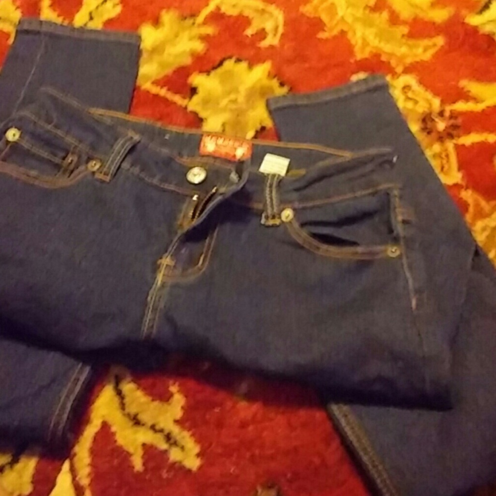 Dark blue jeans gently worn.